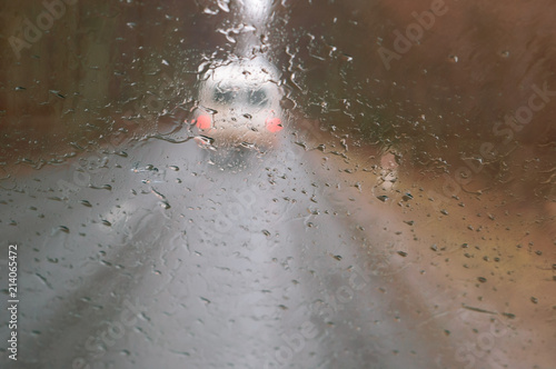 Raindrops on the car window. The road is wet with rain. Rainy weather. © SeagullNady