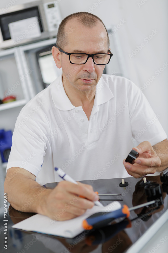 appliance technician writing his notes appliance technician writing his notes