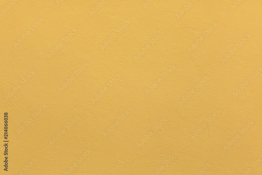 Obraz premium Yellow ochre painted stucco wall. Background texture