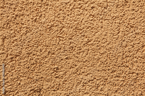 Orange painted stucco wall. Background texture