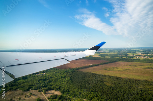 Aerial view of the plane wing with Estonian flag.