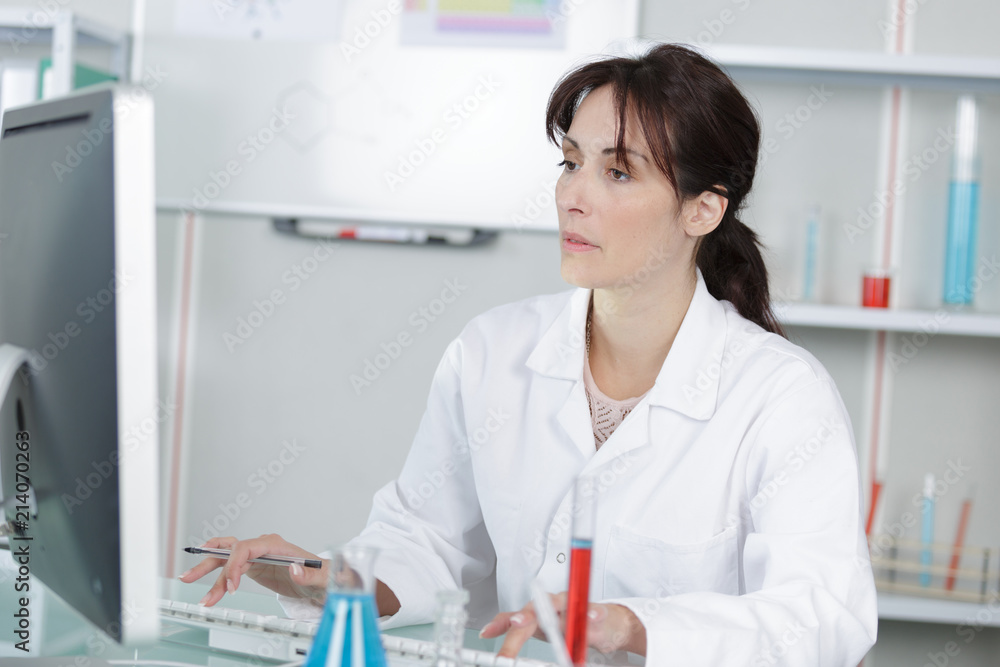 young female scientist working with liquids in laboratory young female scientist working with liquids in laboratory