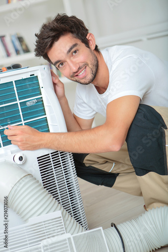 Portrait of man installing air conditioning photo