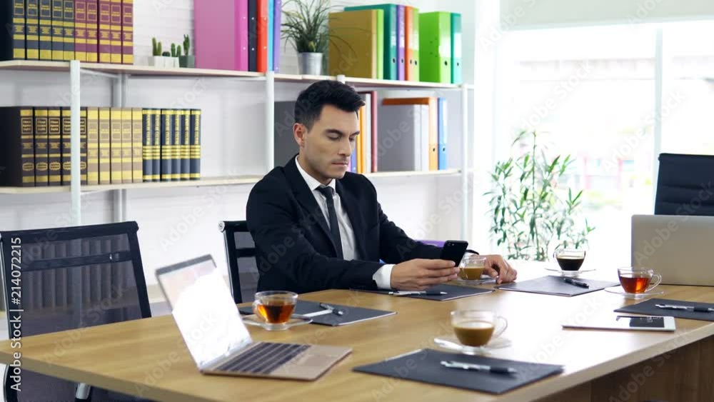 Businessman are checking information through smartphones. Waiting for the meeting Note to editor: Businessman are checking information through smartphones. Waiting for the meeting Note to editor: