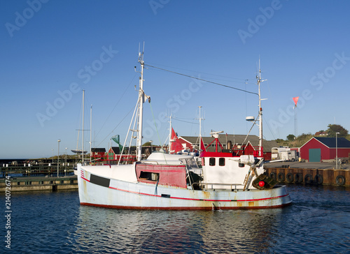 Laesoe / Denmark: A small fishing cutter leaves the harbor of Vesteroe Havn