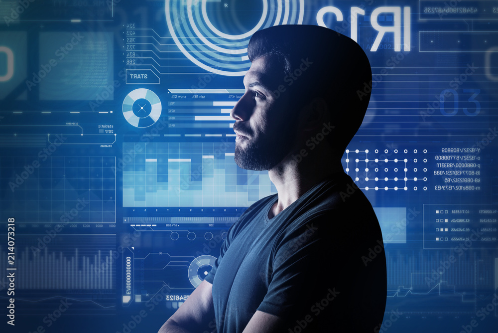 © Viacheslav Yakobchuk - Computer system analyst. Calm computer system analyst thoughtfully looking at the futuristic screen while being in his modern office