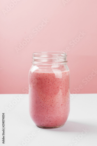 Strawberry smoothies on a pink background