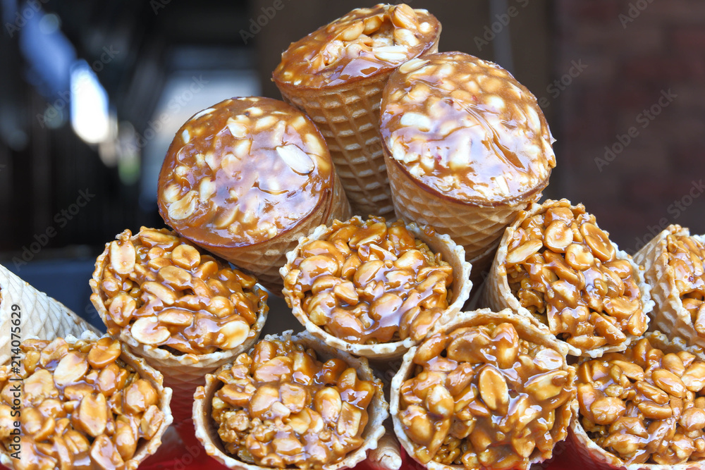 Gozinaky. Candied roasted nuts. Honey bars with peanuts, sesame and sunflower seeds, close-up.