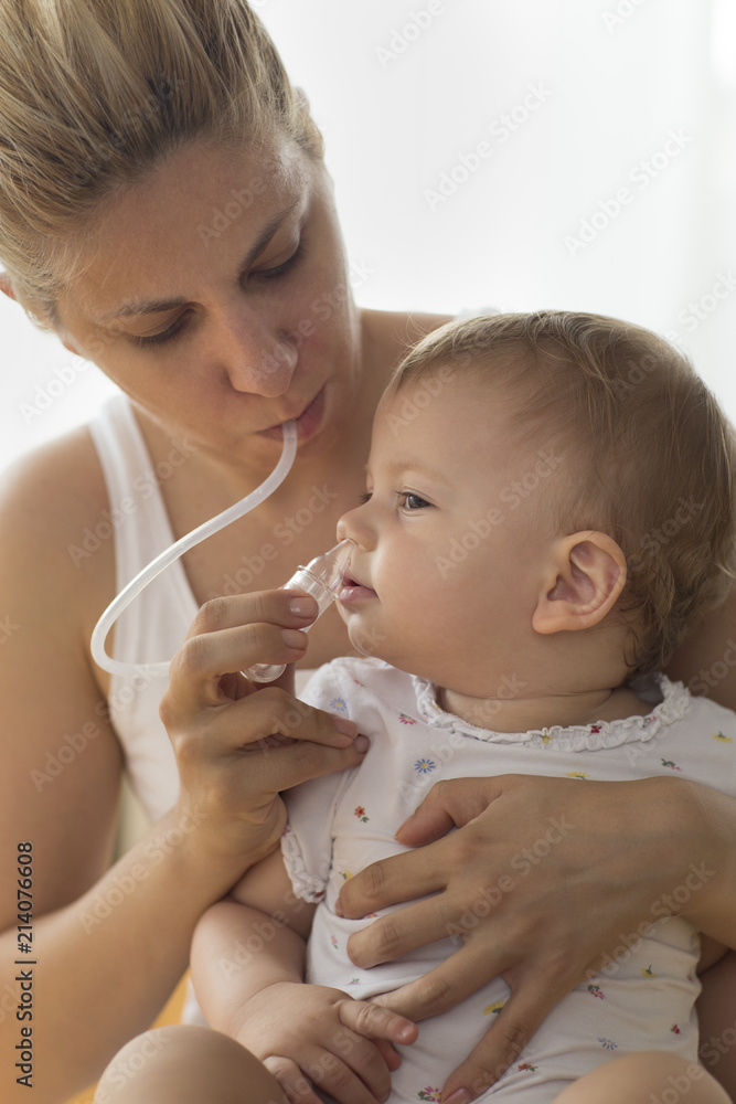 mother cleaning babies nose. nasal aspiration cleaner mother cleaning babies nose. nasal aspiration cleaner