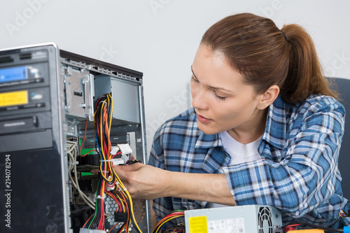 Woman repairing tower computer