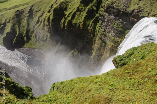 Stunning view of the famous Skogafoss waterfall in southern Iceland on a sunny summer day.