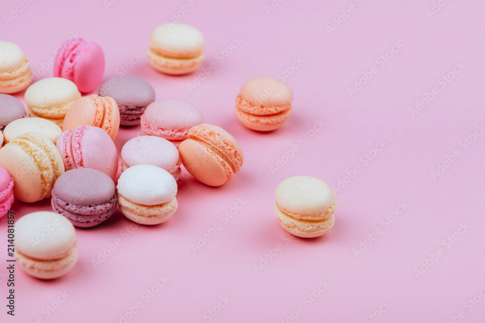 Obraz premium Different types of macaroons on pink background.