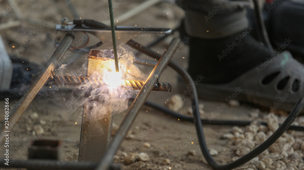 Worker welds metal at the construction site