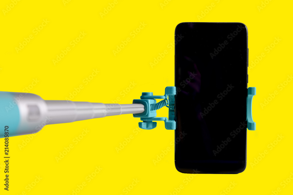 Monopod for selfie with smart phone. Selfie stick with smartphone isolated on white background Monopod for selfie with smart phone. Selfie stick with smartphone isolated on white background