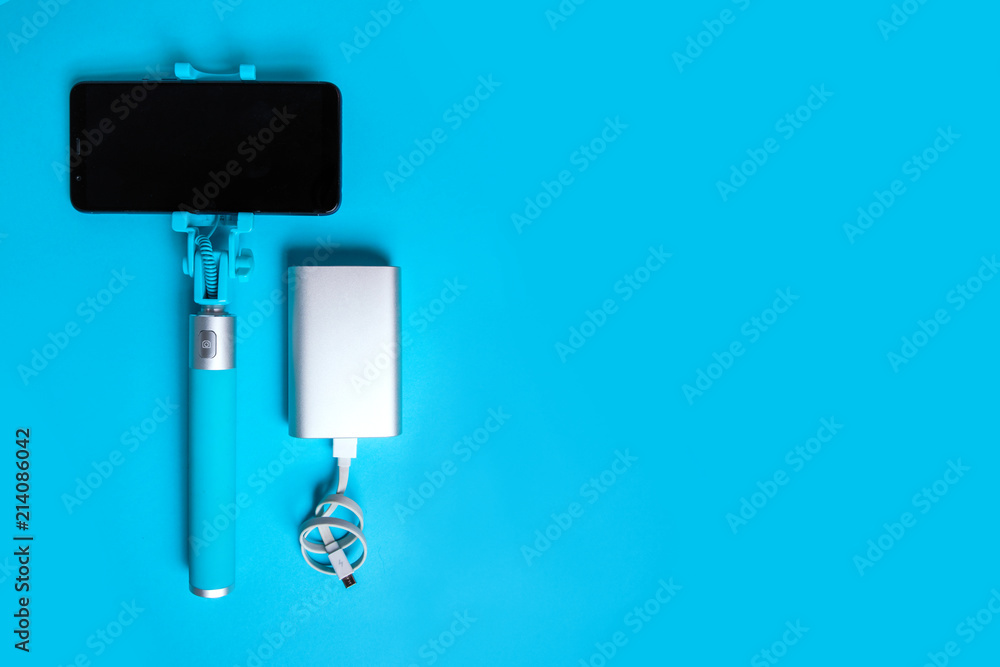 Set for photographing and traveling monopods with smartphone for selfie and power bank. Stick with smartphone isolated Set for photographing and traveling monopods with smartphone for selfie and power bank. Stick with smartphone isolated