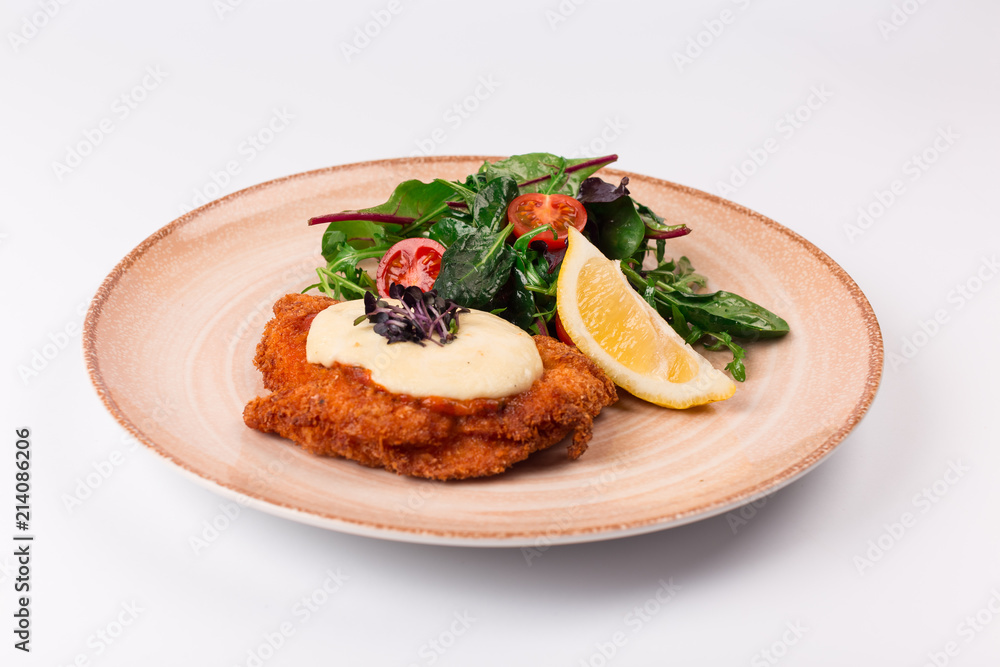 Top and front view isolated - Chicken parmesan cheese and mixed salad.
