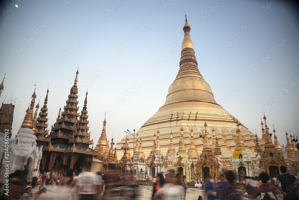 Naklejka premium The Shwedagan Paya is one of Mynamar's most important sites adorned with 27 metric tons of gold leaf, thousands of gems and a 70+ karat diamond up top.