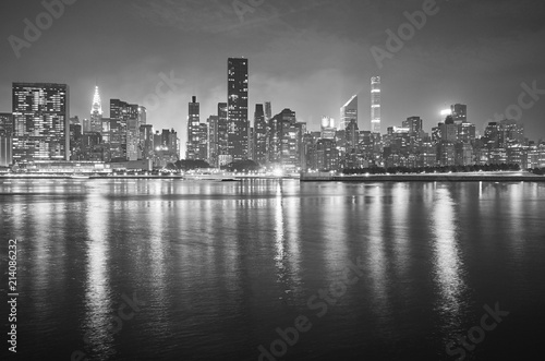 Black and white picture of Manhattan at night, New York City, USA.