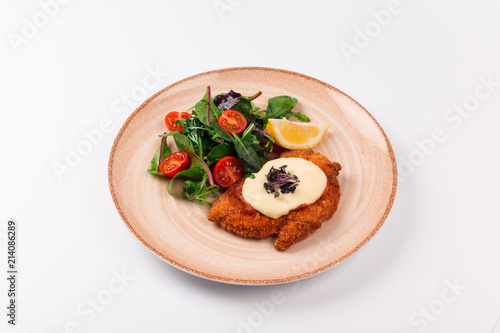 Top and front view isolated - Chicken parmesan cheese and mixed salad.