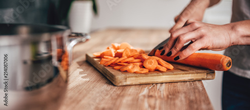 Woman cutting carrot