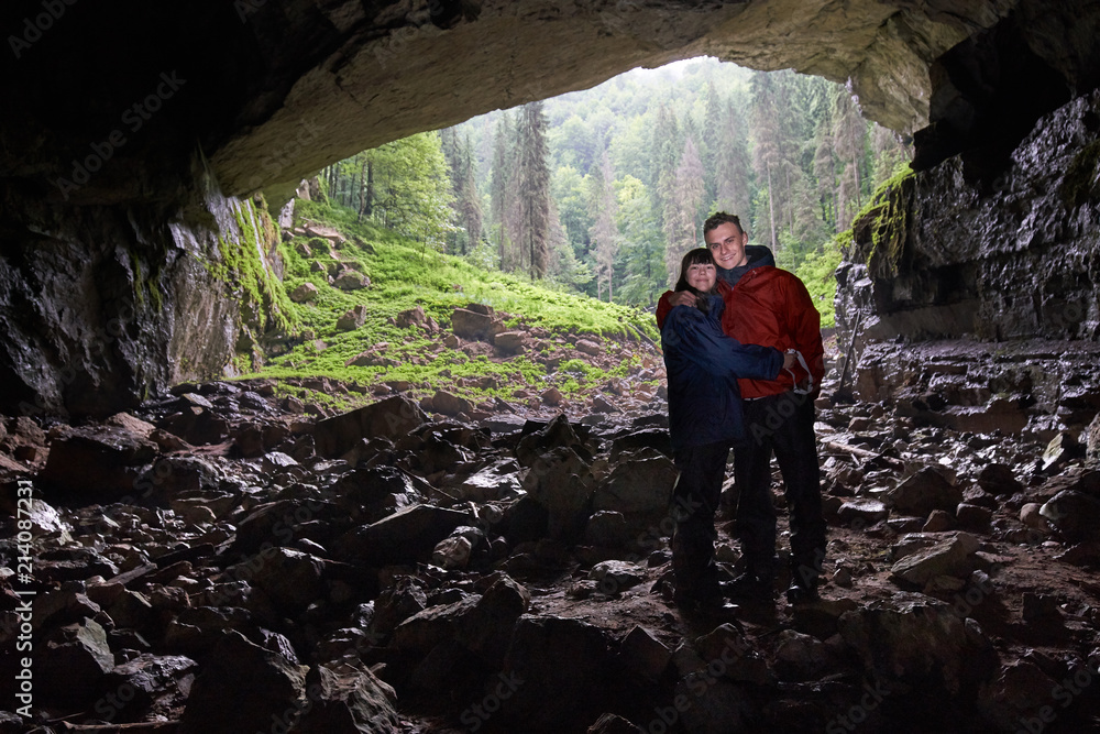 Couple of hikers exploring a cave