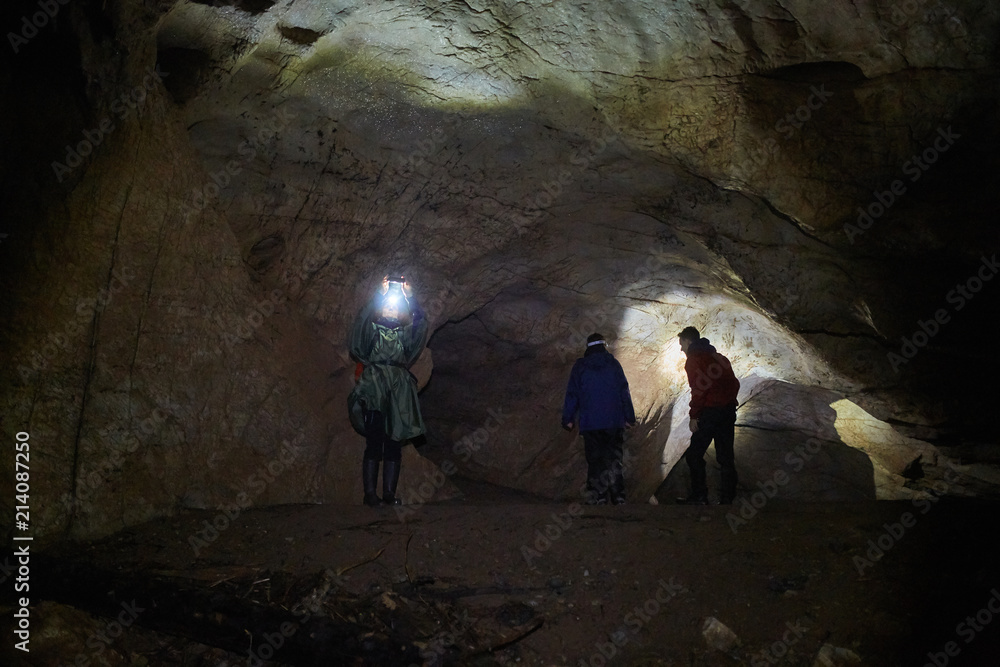 Hikers family exploring a cave