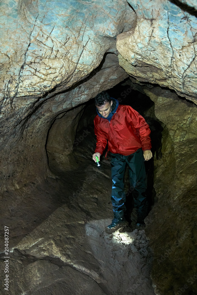 Young kid exploring a cave