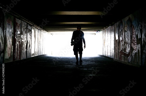 Young man going to ligh in a tunnel