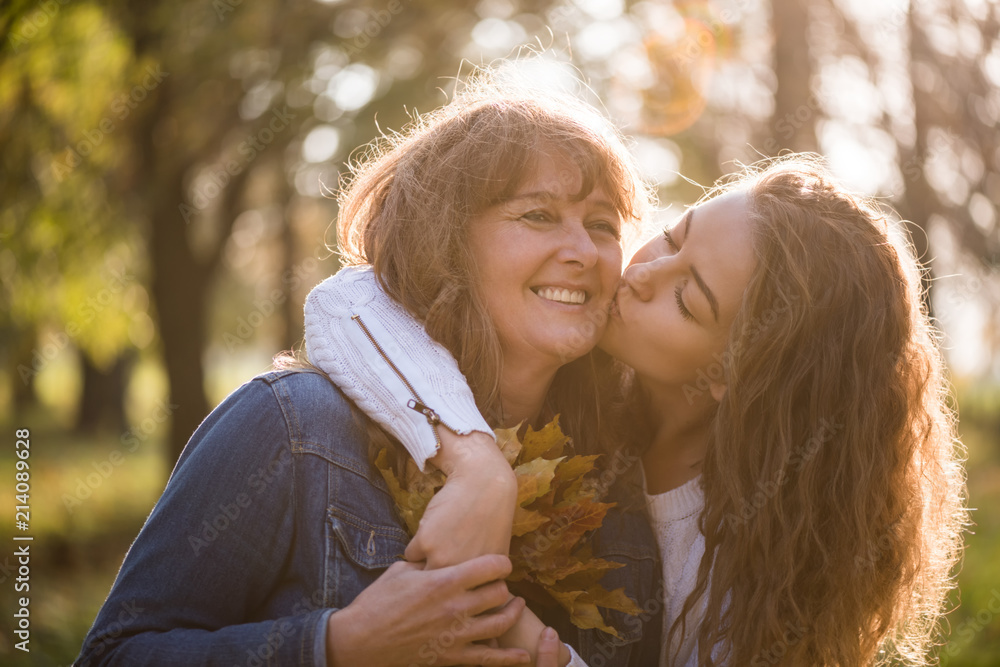 Fototapeta premium Adult daughter hugging her mother