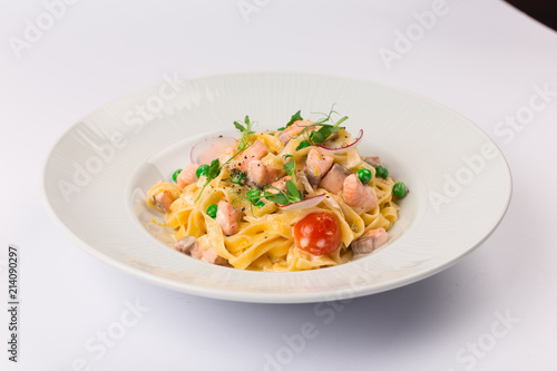 Front and top view isolated - Tagliatelle with salmon and tomatoes. 