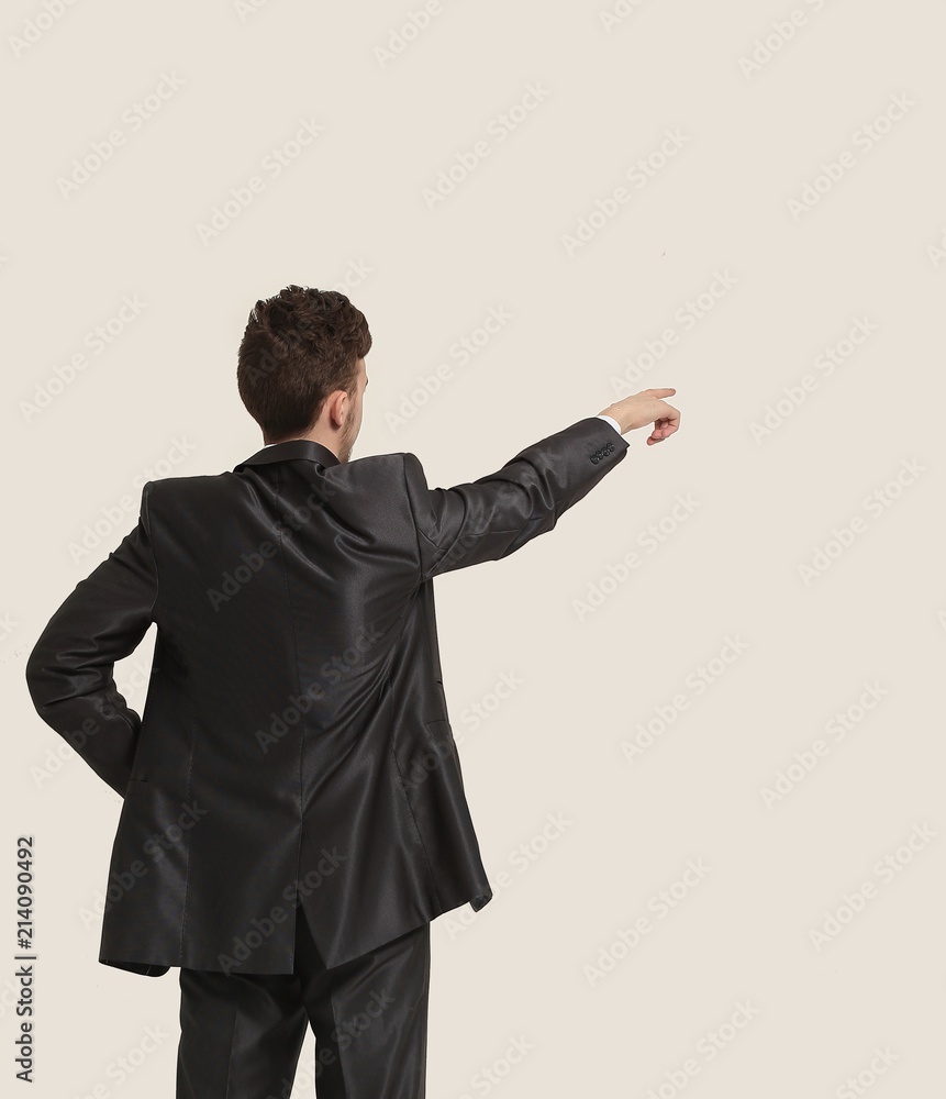 Full length of business man pointing at copyspace