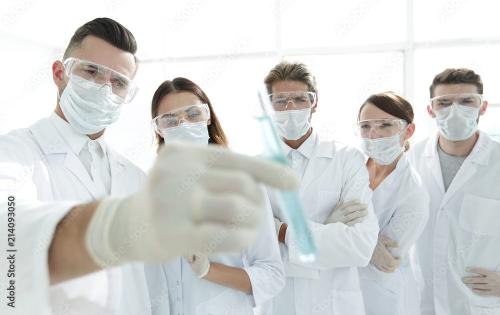 background image is a group of medical workers working with liquids in laboratory background image is a group of medical workers working with liquids in laboratory