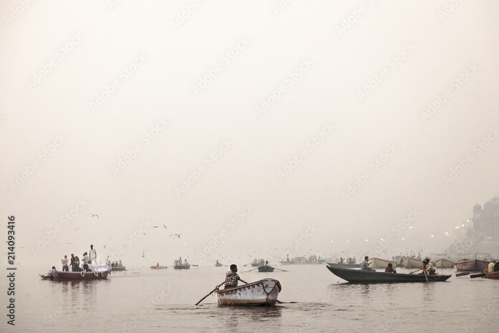 03.01.16. Varanasi, India. Tour boats escort tourists at sunrise on the Ganges River.