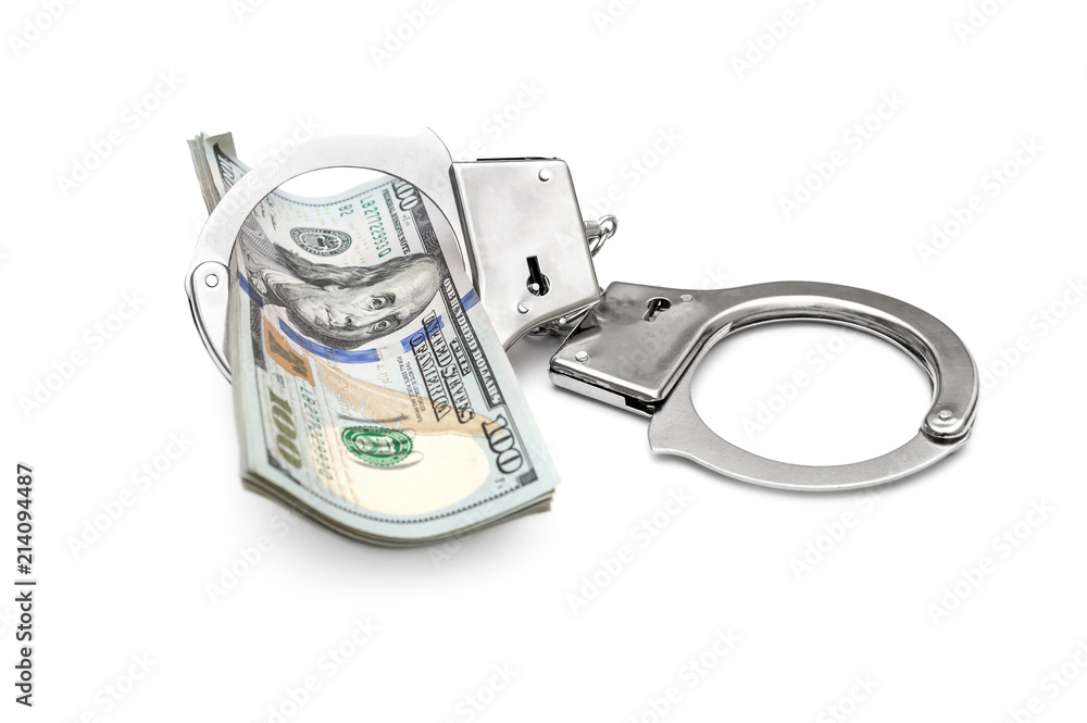 Handcuffs with dollar bills on white. Handcuffs with dollar bills on white.
