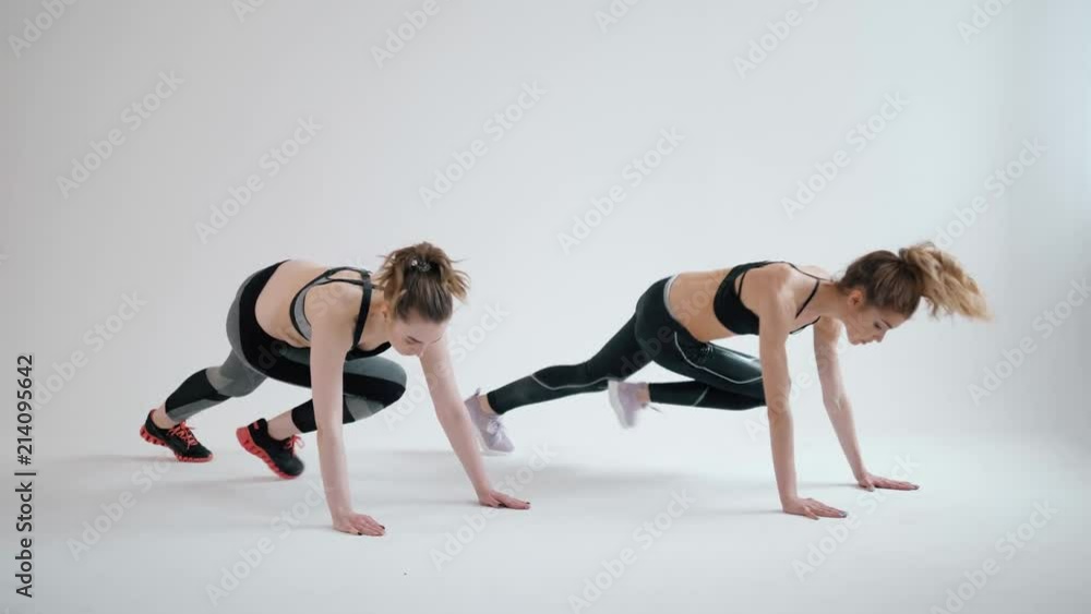 Fitness, stretching practice, group of two attractive happy smiling fit young women working out in sports club, doing Extended Side Angle close up dance happy Fitness, stretching practice, group of two attractive happy smiling fit young women working out in sports club, doing Extended Side Angle close up dance happy