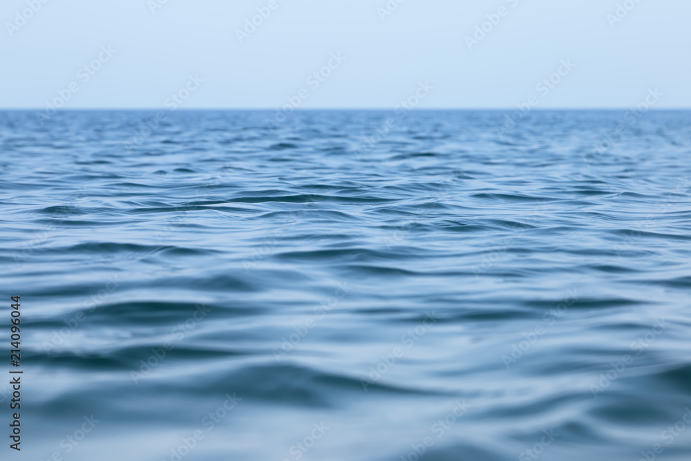 Naklejka premium Surface of the sea with small waves. Seascape under a clear sky in a calm.
