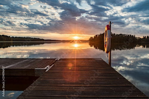 Beautiful sunset at a lake in sweden with a lifesaver in the front photo