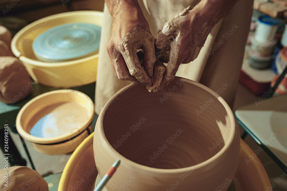 Creating a jar or vase of white clay close-up. Master crock. Creating a jar or vase of white clay close-up. Master crock.