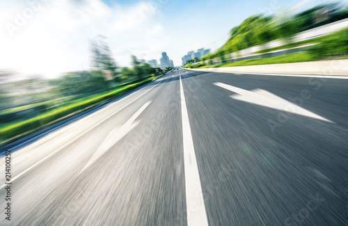 empty asphalt road with city skyline