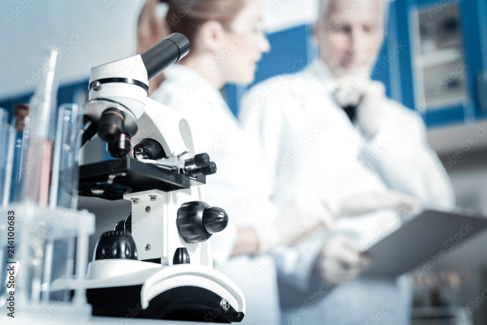 Biological laboratory. Selective focus of a professional modern microscope standing in the biological laboratory Biological laboratory. Selective focus of a professional modern microscope standing in the biological laboratory