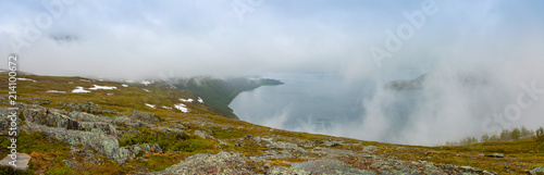 Panorama of nature view with fjord and mountains in clouds in Norway