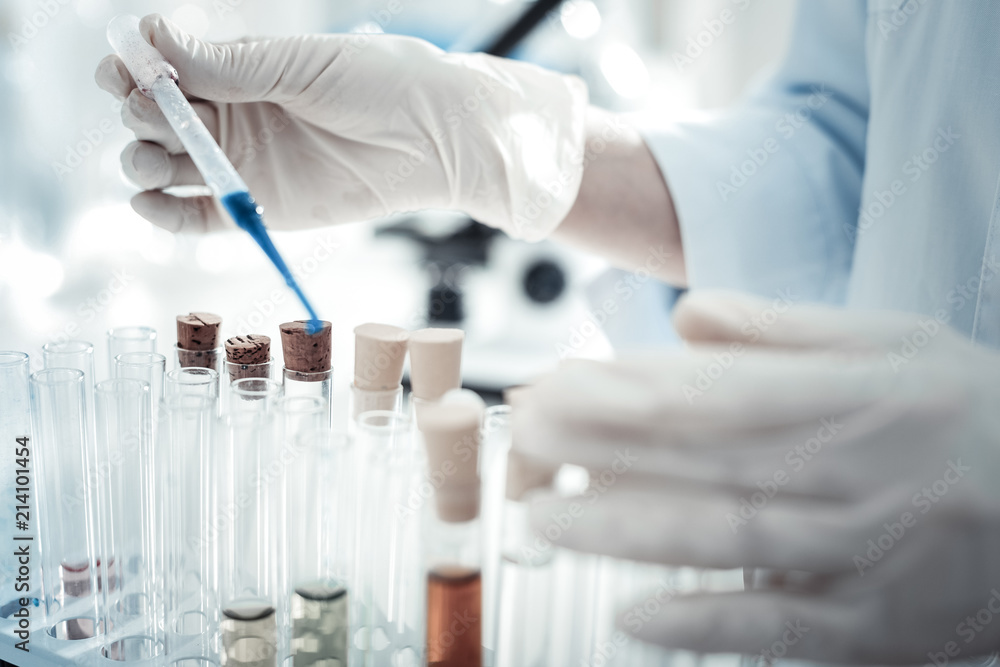 For the analysis. Close up of a test sample being taken from a test tube for professional biological analysis For the analysis. Close up of a test sample being taken from a test tube for professional biological analysis