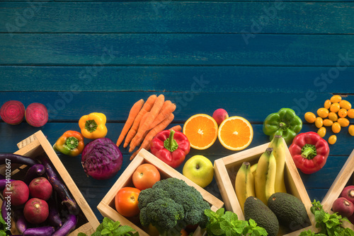 Fototapeta Naklejka Na Ścianę i Meble -  Flat lay of fresh  fruits and vegetables for background, Different fruits and vegetables for eating healthy, Colorful fruits and vegetables on blue plank background