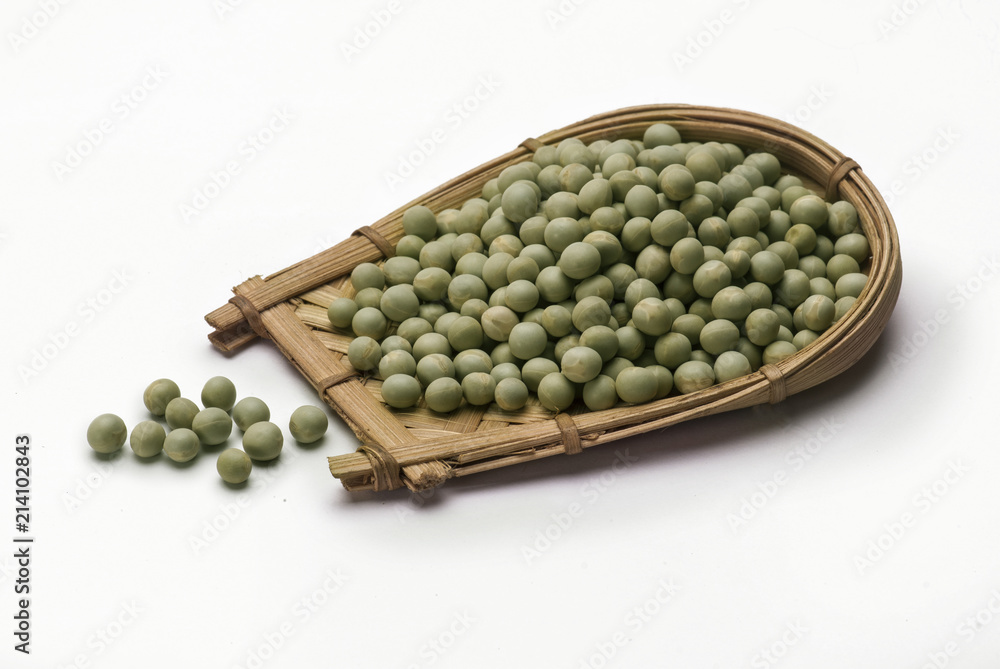 Green peas in cane basket isolated on white background Green peas in cane basket isolated on white background
