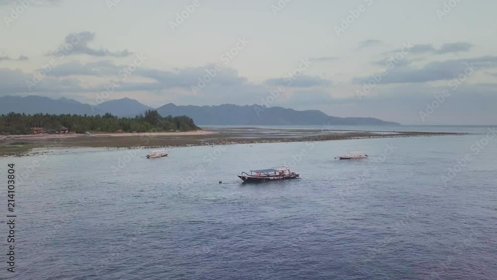 Aerial view of a sunset over the ocean and boat