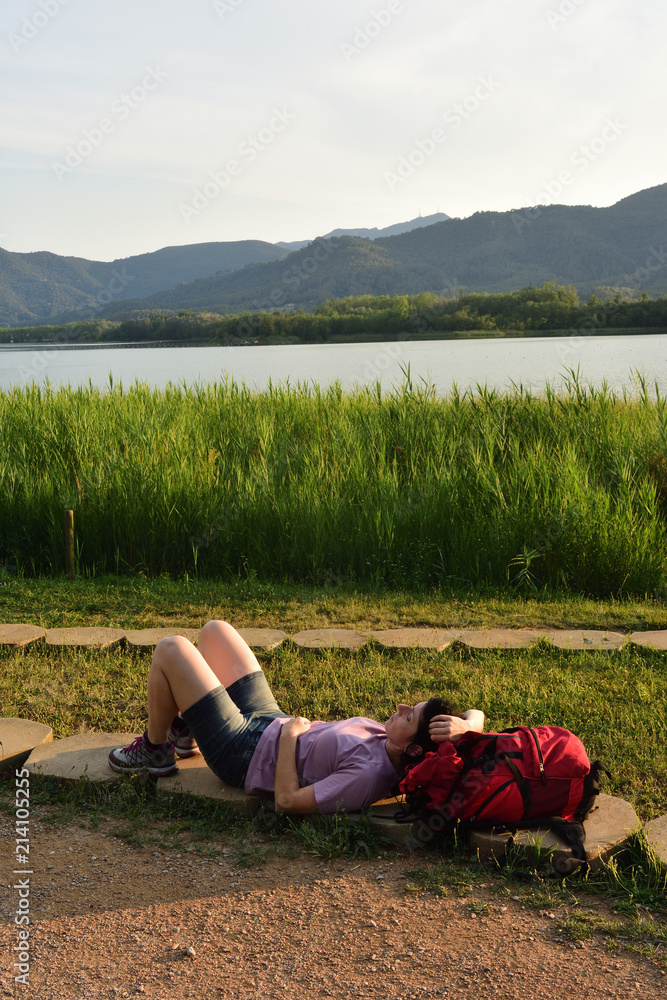 Hiker woman resting after walking Hiker woman resting after walking