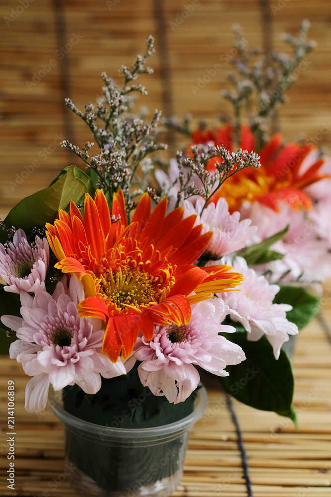 colorful chrysanthemum flower and leaves in small cup with humidified oasis and have some space for write wording, new innovative blossom design for beauty and ease of use generate new market business