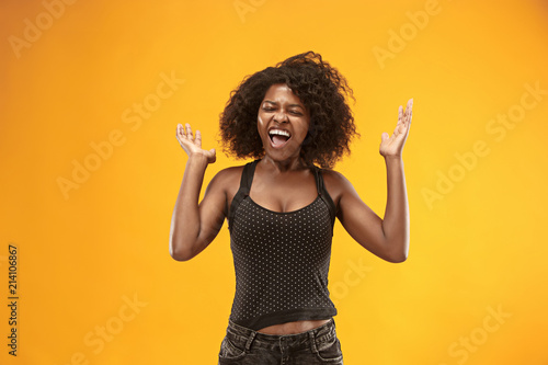 Winning success woman happy ecstatic celebrating being a winner. Dynamic energetic image of female afro model