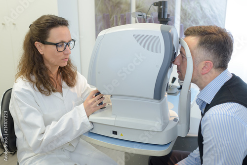 ophthalmologist examining mans eyes