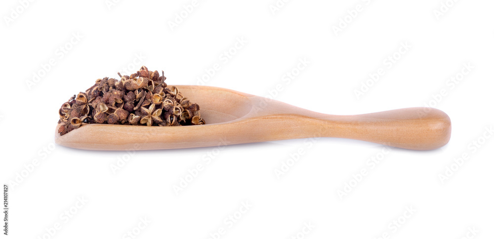 Dry Zanthozylum limonella Alston in wooden spoon on white background. Dry Zanthozylum limonella Alston in wooden spoon on white background.